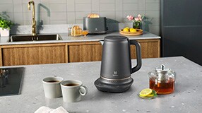 Kettle and two mugs on a table