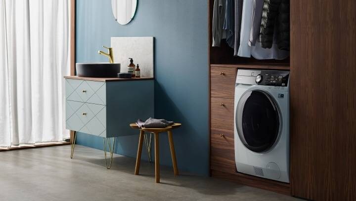 A built-in washer-dryer in a stylish and modern bathroom
