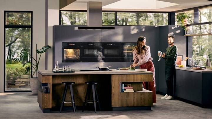 Man and woman making food in a kitchen